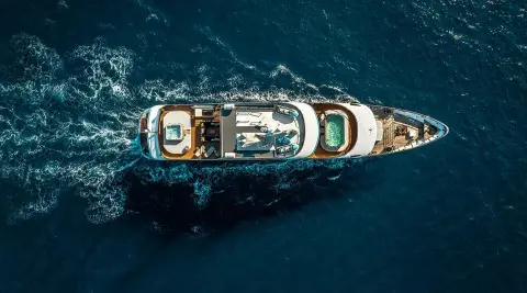 Aerial view of a luxury yacht named Freedom cruising blue ocean