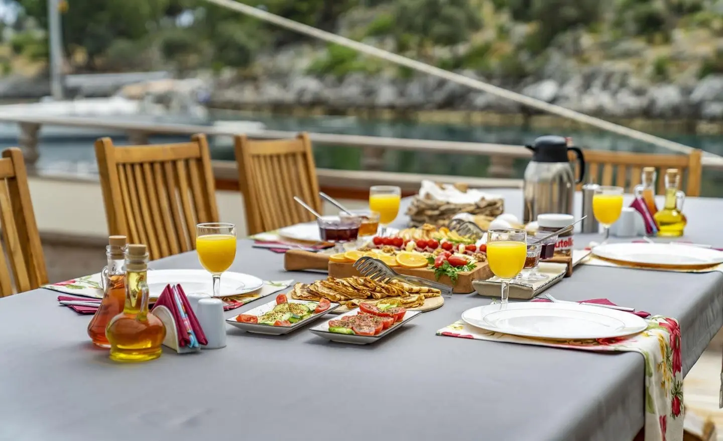 Tersane 8 yacht scene with a table set for meals at sunset on deck