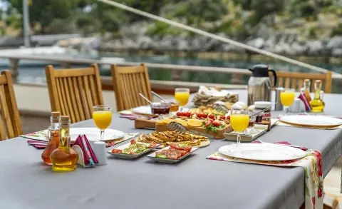 Tersane 8 yacht scene with a table set for meals at sunset on deck