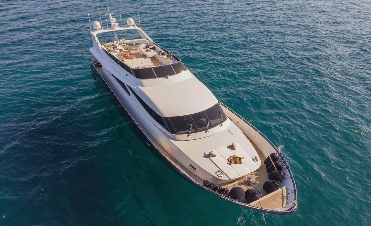 Yacht Zoi anchored in calm blue water, top deck visible from above
