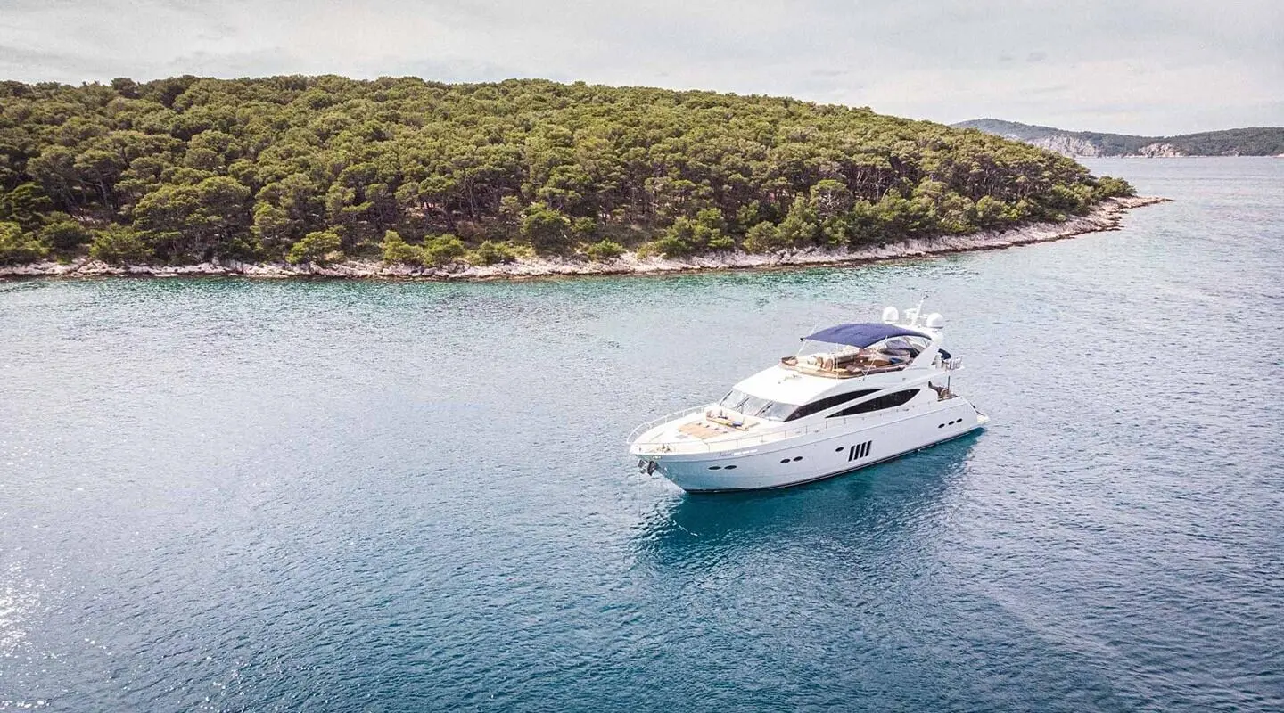 White motor yacht on the sea with sunbathing area on the deck