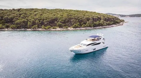White motor yacht on the sea with sunbathing area on the deck