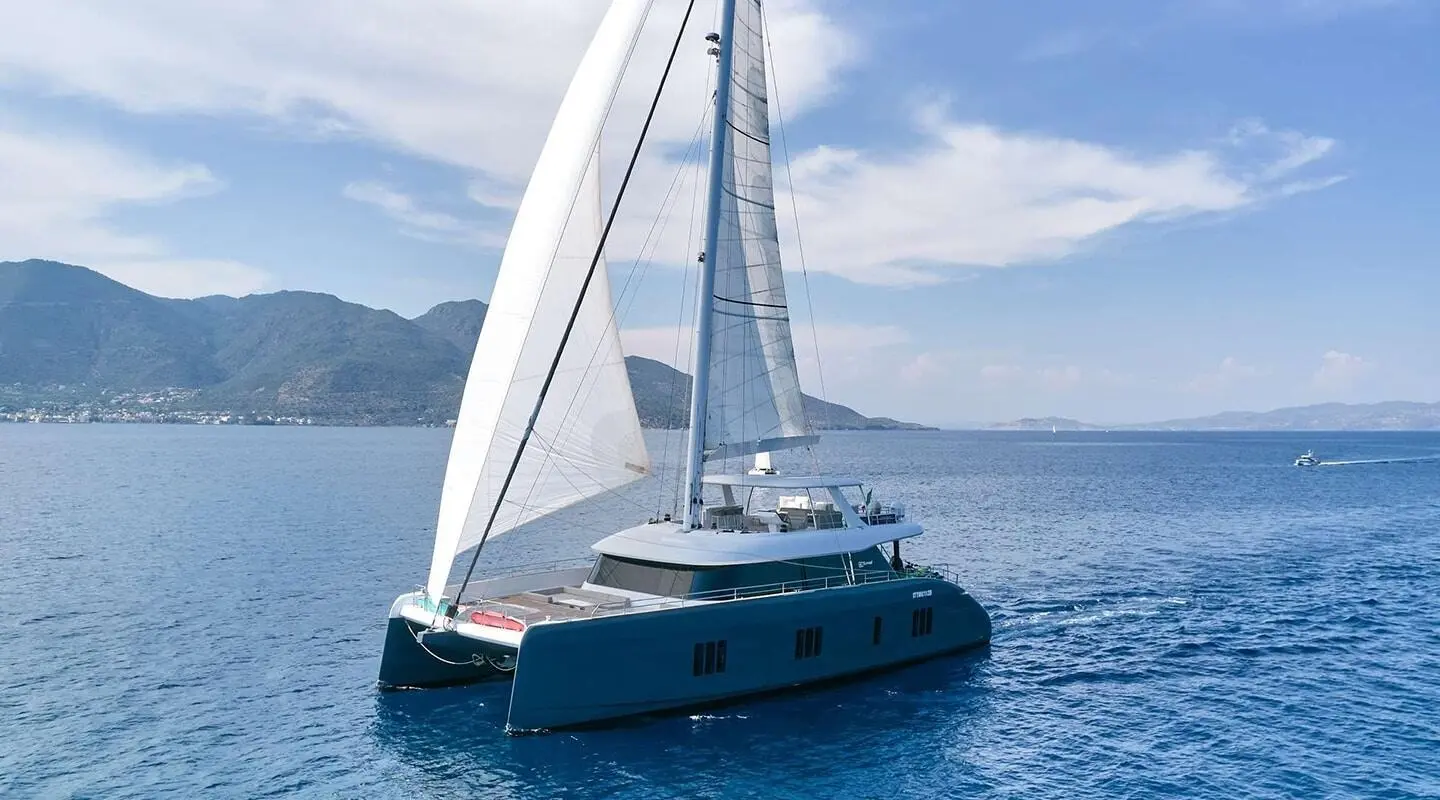 Gulet Genny sailing on calm blue sea with white sails raised
