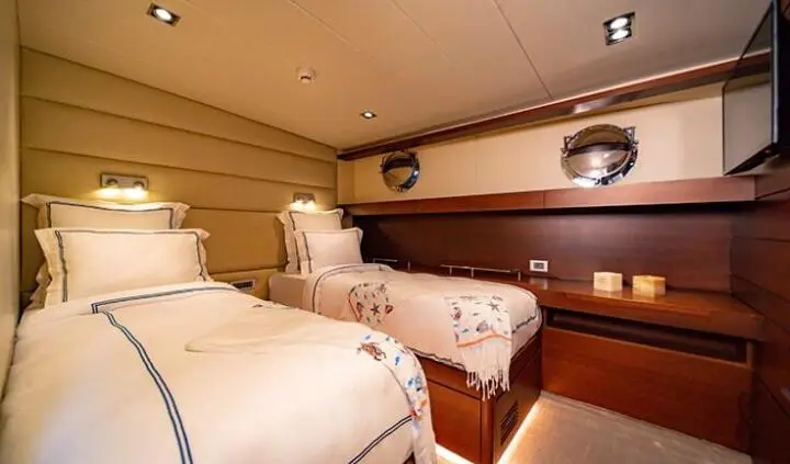 Twin cabin ensuite beds on yacht Double Eagle interior with wood paneling