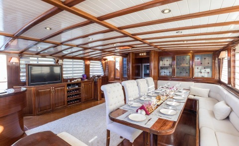 Grace 1 yacht interior with wooden cabinets and a dining table