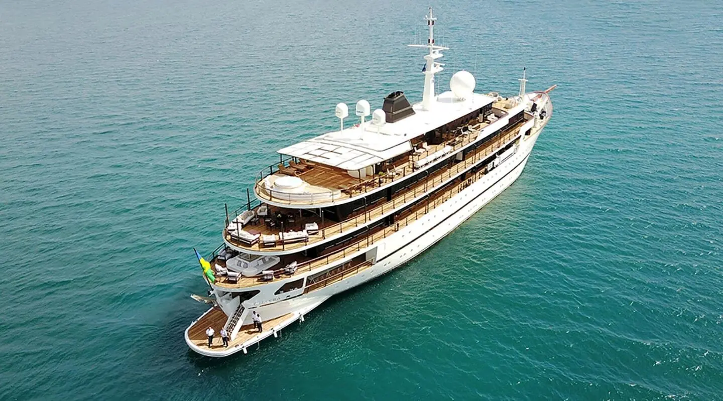 A luxury Chakra yacht anchored in turquoise water, aerial view from above