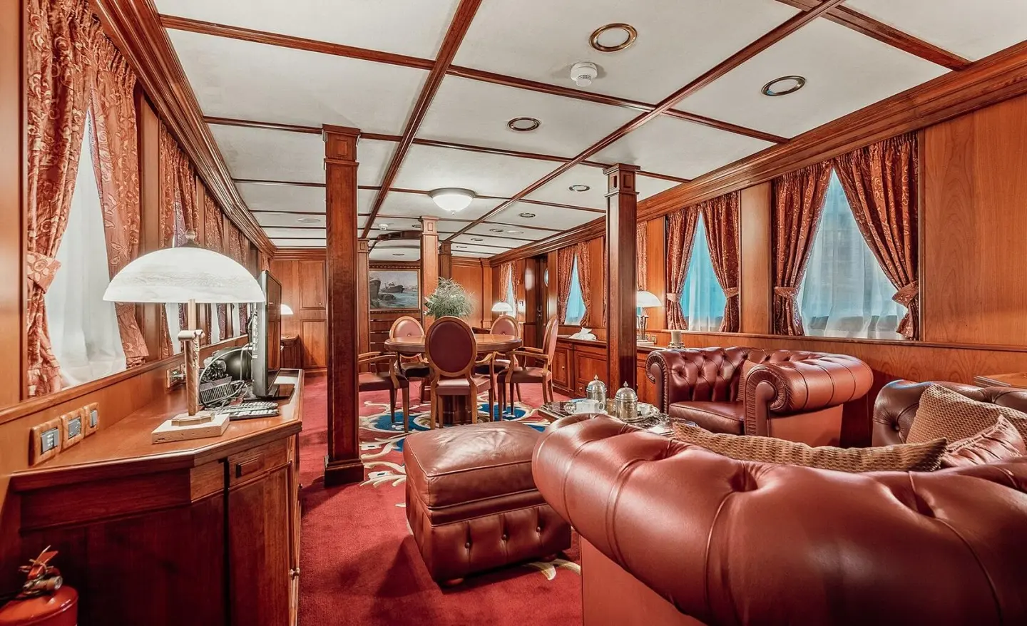 Seagull II luxury yacht interior saloon with red leather seats and wood accents