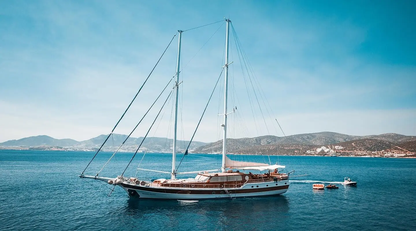 Gulet yacht Wicked Felina anchored in calm blue water with sails down