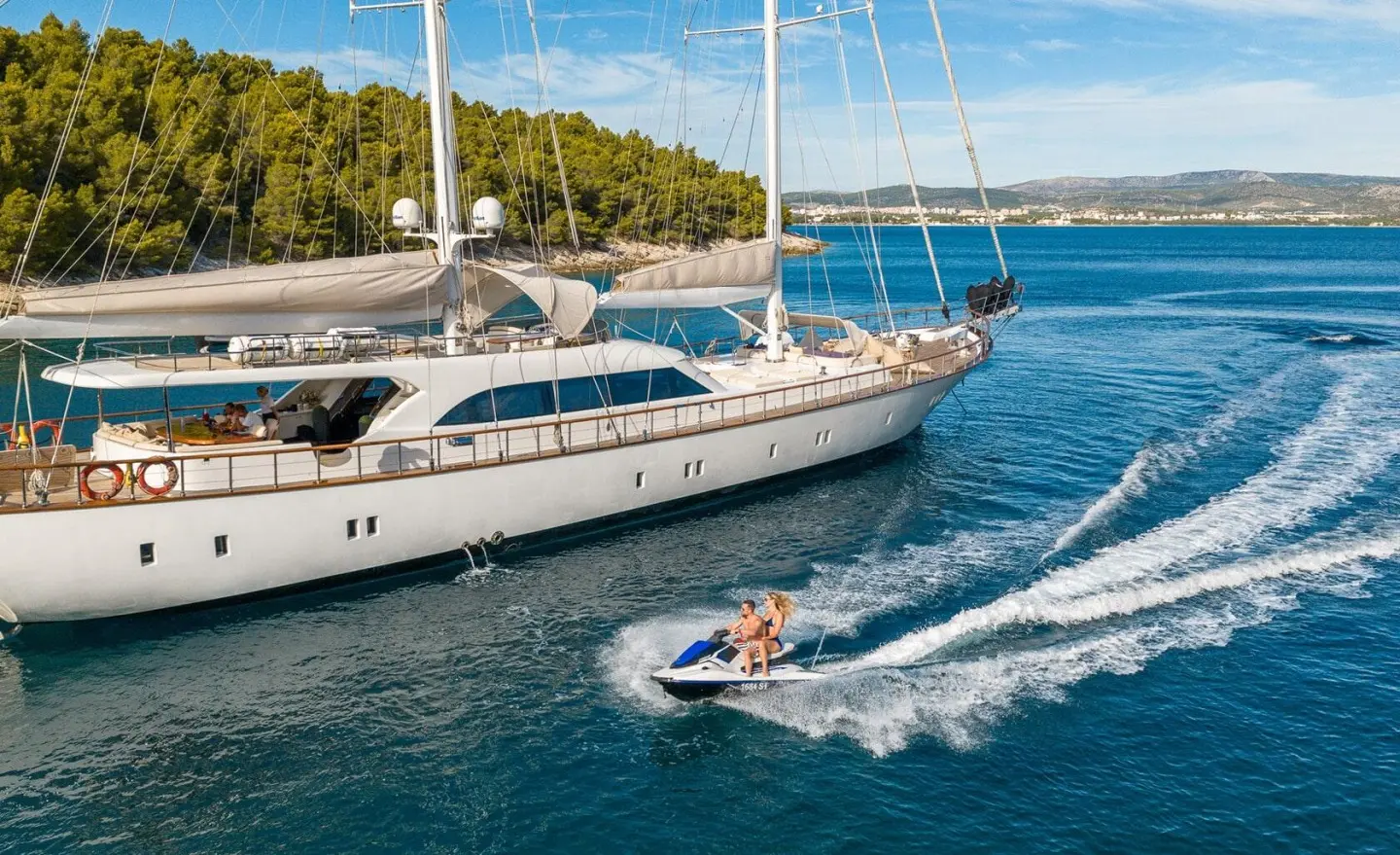 Gulet Alessandro I yacht anchored with others in calm blue water, sunny sky