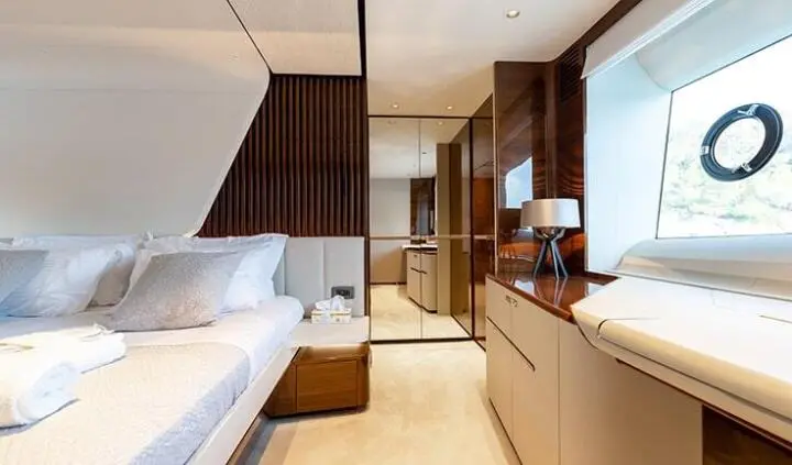 Vista cabin with bed, nightstand, and window view on yacht interior