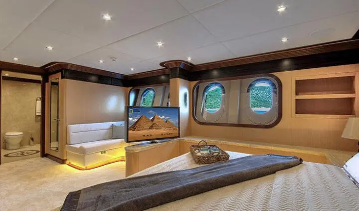 Meira yacht master cabin with king bed, ensuite, wood paneling, portholes