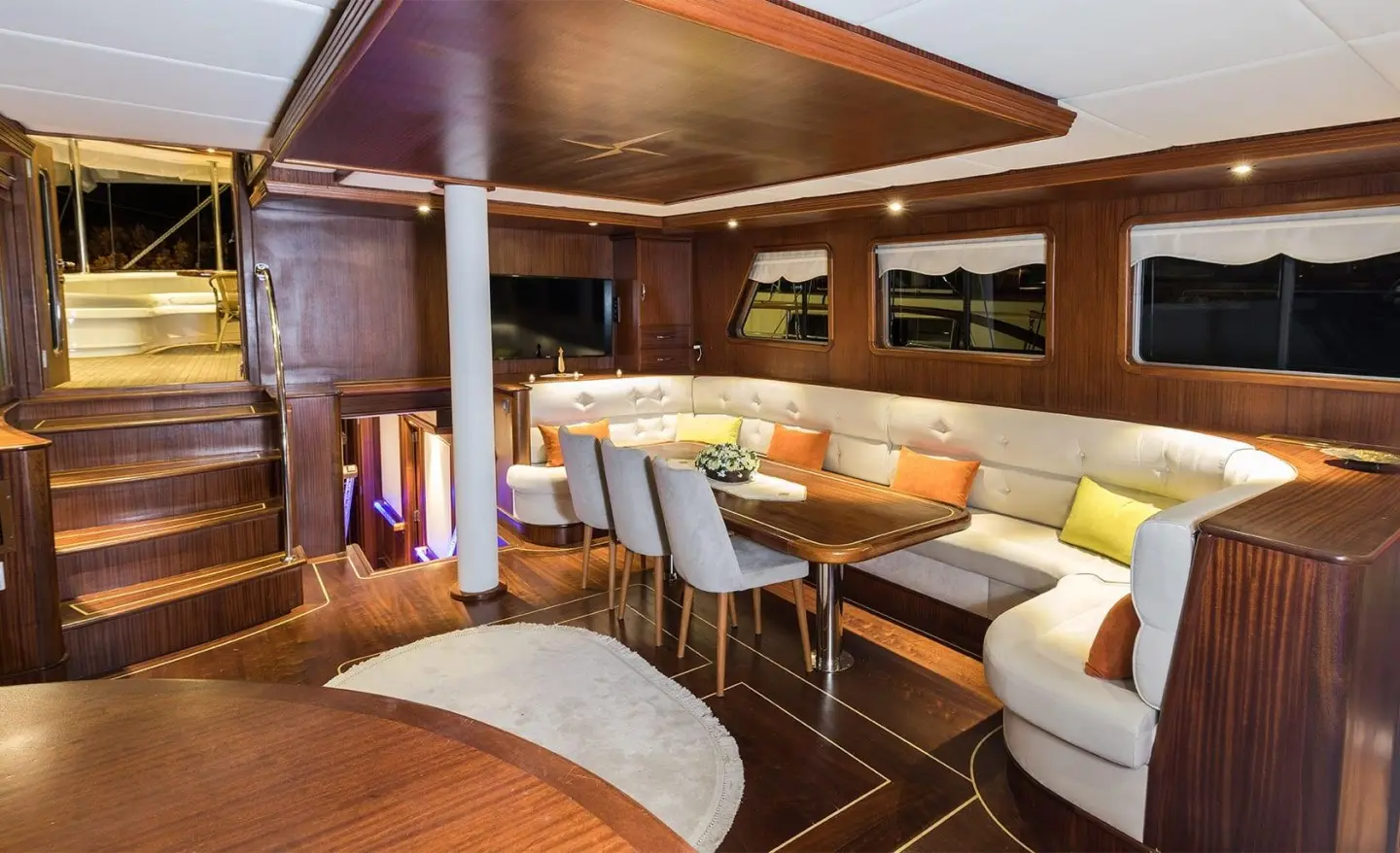Luxurious wood-finished interior with a dining area and windows
