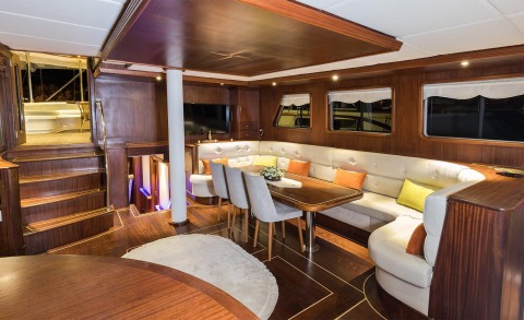 Luxurious wood-finished interior with a dining area and windows