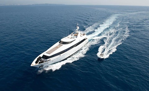 Brooklyn luxury yacht cruising the blue sea, white superstructure, wake behind, spacious deck area