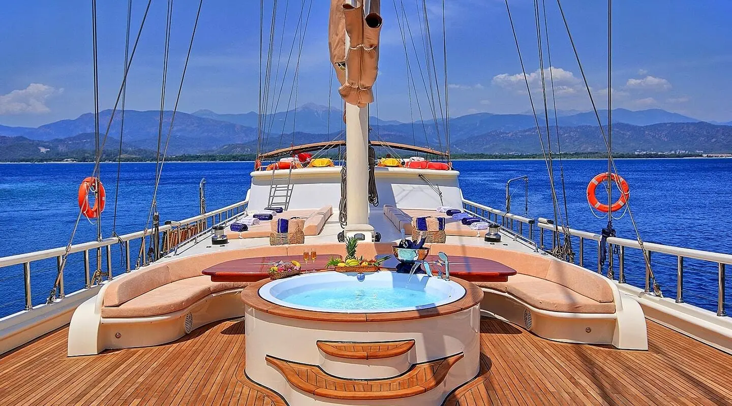 Queen Of Salmakis yacht deck with sunlit wooden surface and blue sea horizon