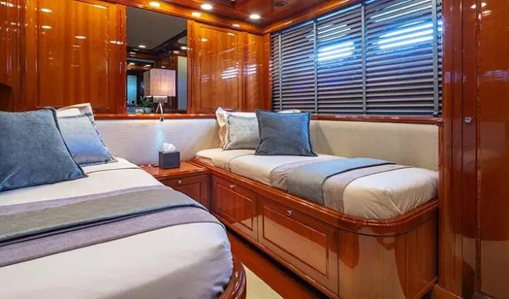 Twin cabin aboard Divine yacht with wooden interior, two single beds