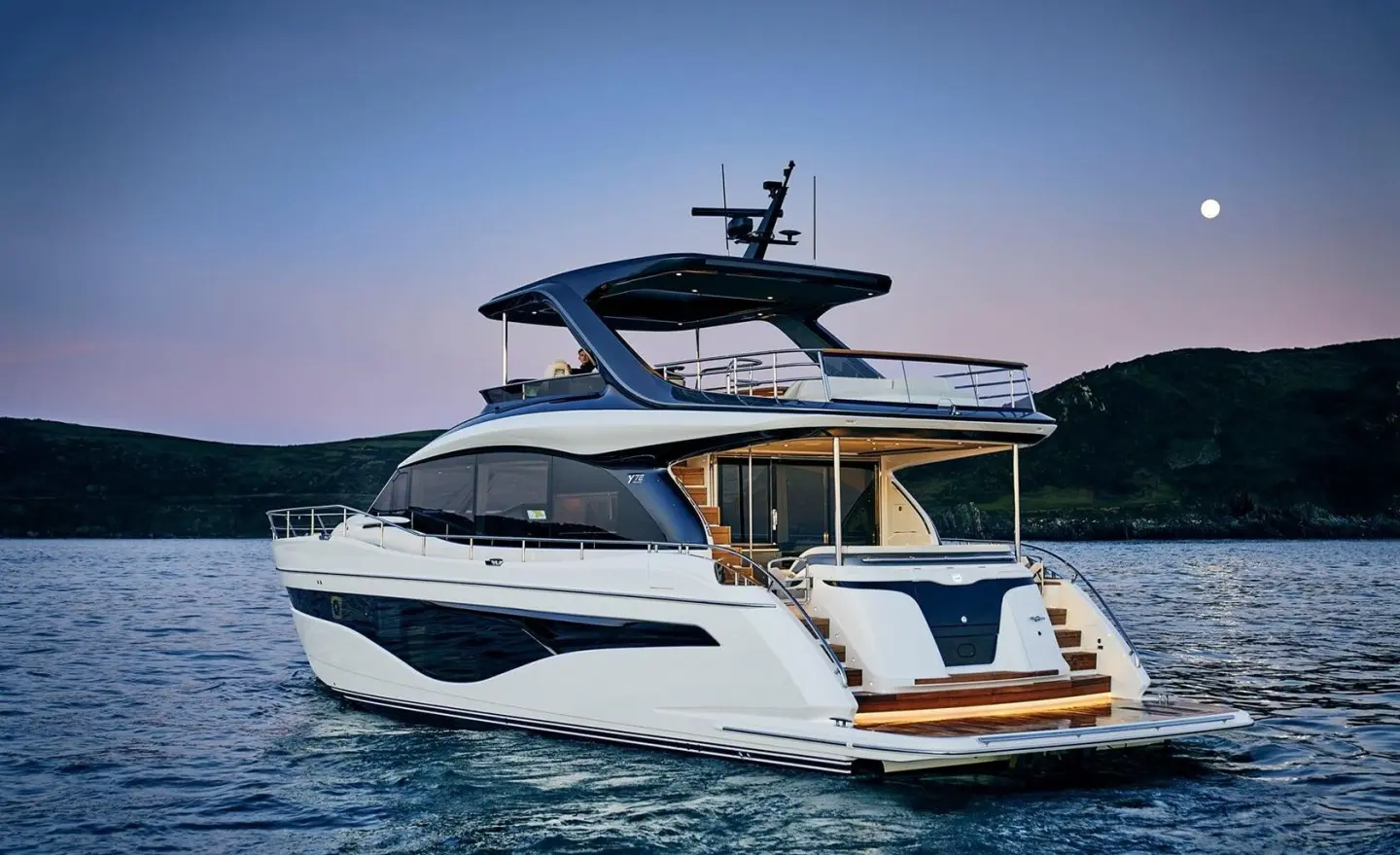 Elizabeth motor yacht anchored with flybridge and white hull on calm sea