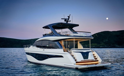 Elizabeth yacht anchored at twilight with open upper deck and white hull, glass cabin windows and rear seating