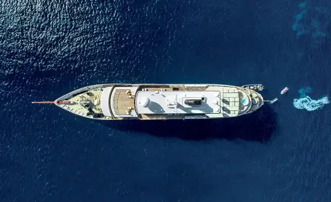 Aerial view of the Chakra yacht cruising in open sea, deck and superstructure visible