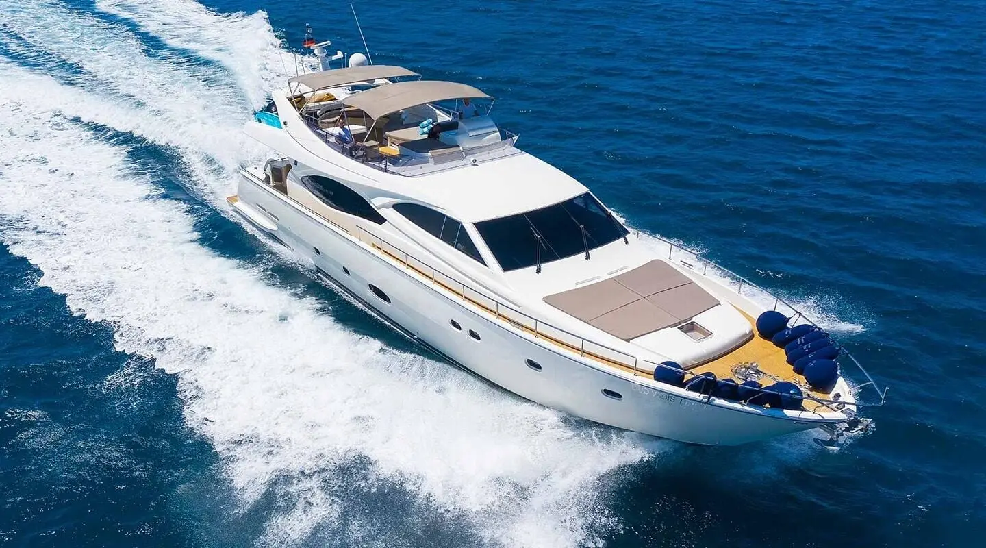 Quo Vadis I luxury yacht cruising on blue sea at sunset with wake