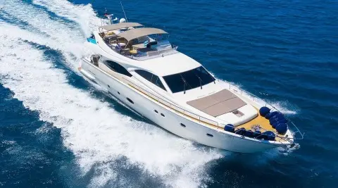 Quo Vadis I luxury yacht cruising on blue sea at sunset with wake