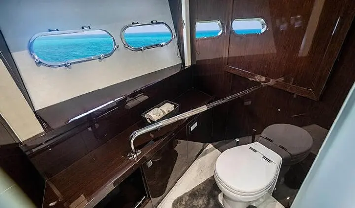 Quantum cabin with king bed visible through windowed yacht interior, compact space