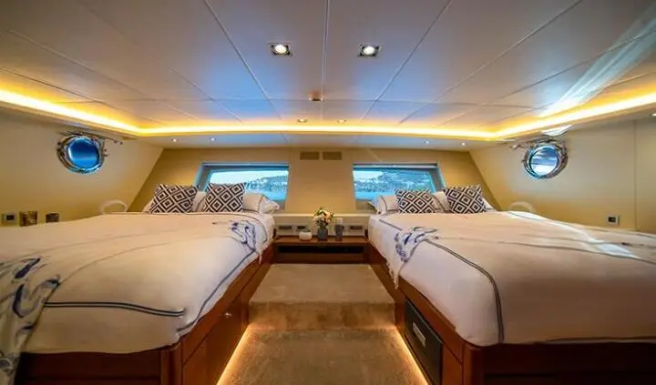 Inside Double Eagle cabin with two parallel beds and wood accents