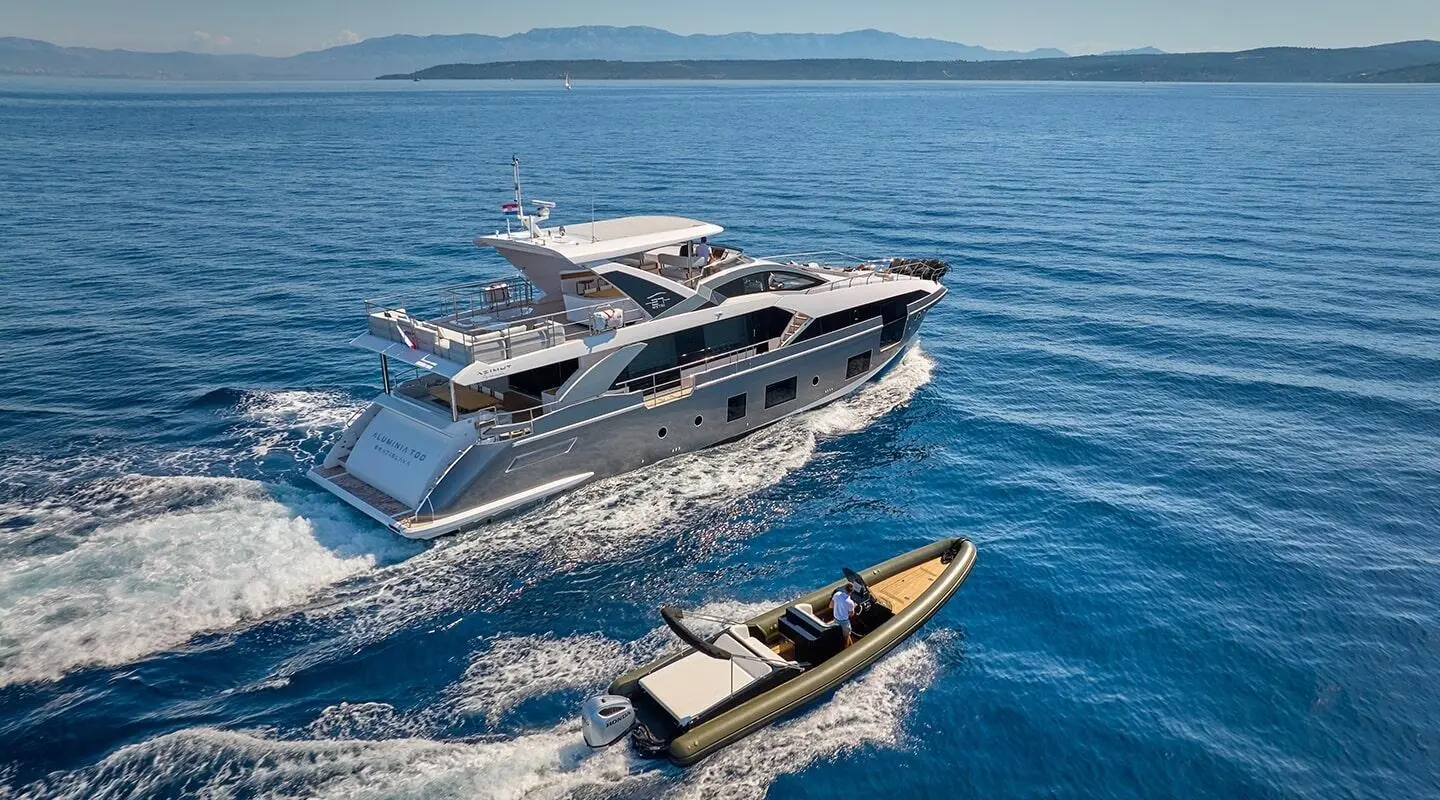 Aluminia Too luxury yacht cruising with a small tender on blue sea