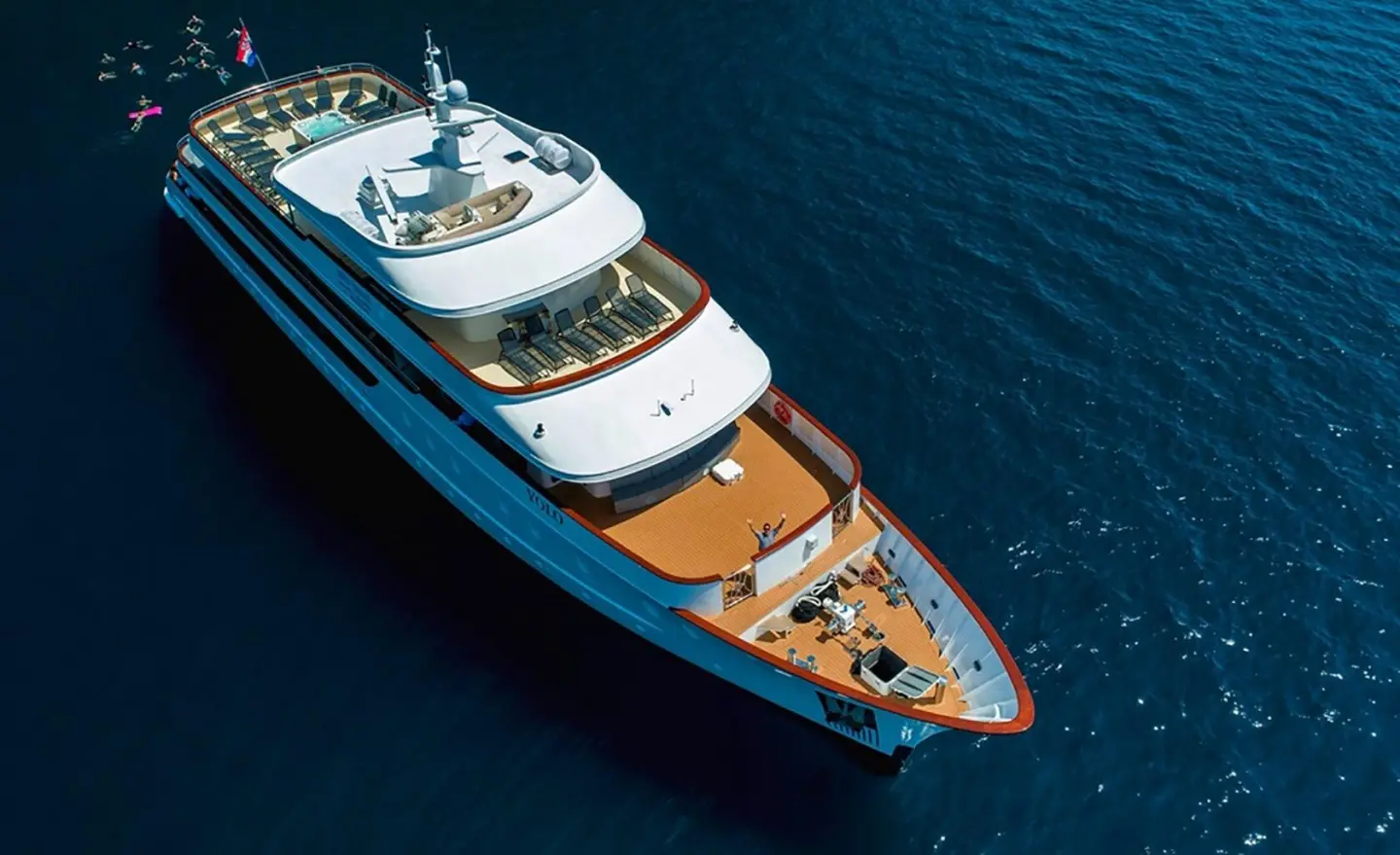 Aerial view of the Yolo luxury yacht anchored in calm blue water with sun deck