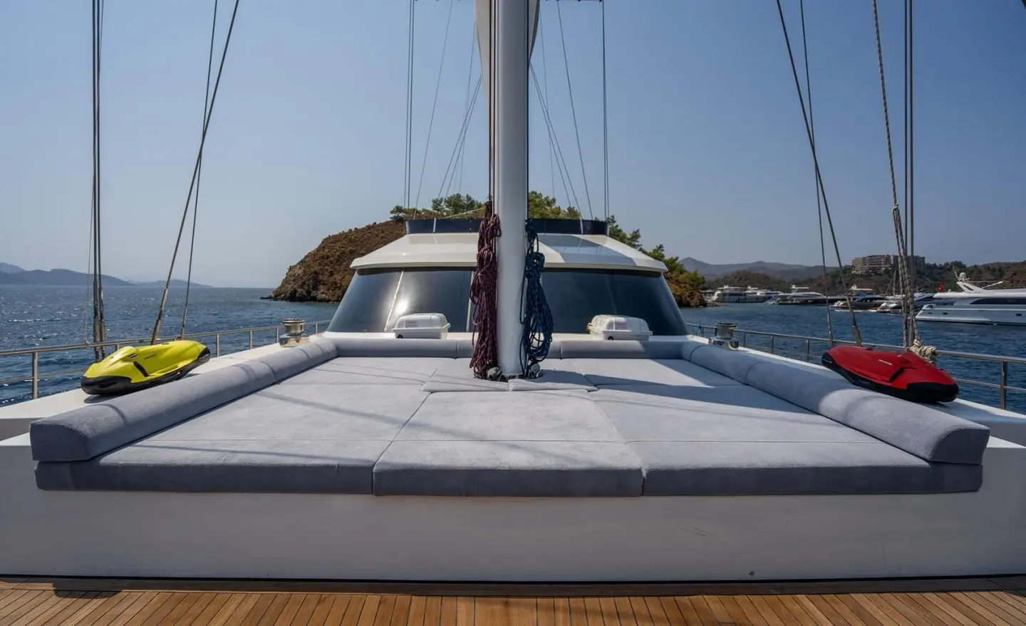 Sunlit rear deck of luxury yacht De Love, calm sea in background