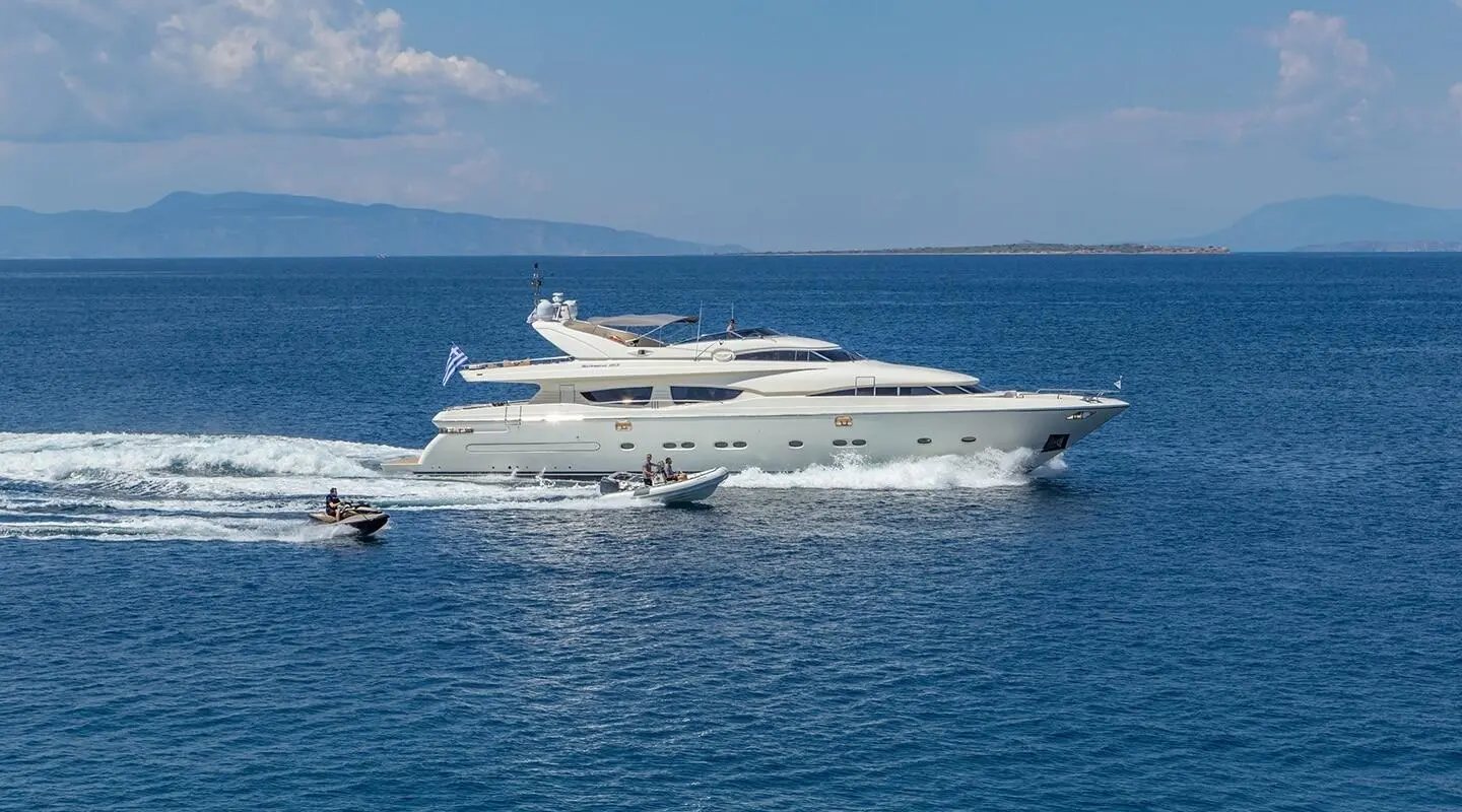 Luxury yacht named Divine anchored in calm blue sea with clear sky backdrop