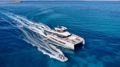 Overhead view of Christal Mio yacht cruising, wake trailing at sea