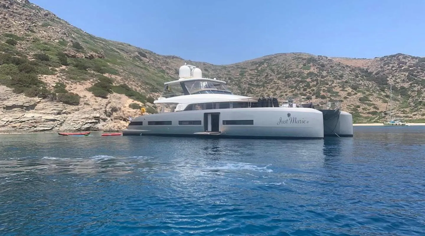 Just Marie 2 yacht anchored near rocky coastline with clear blue water
