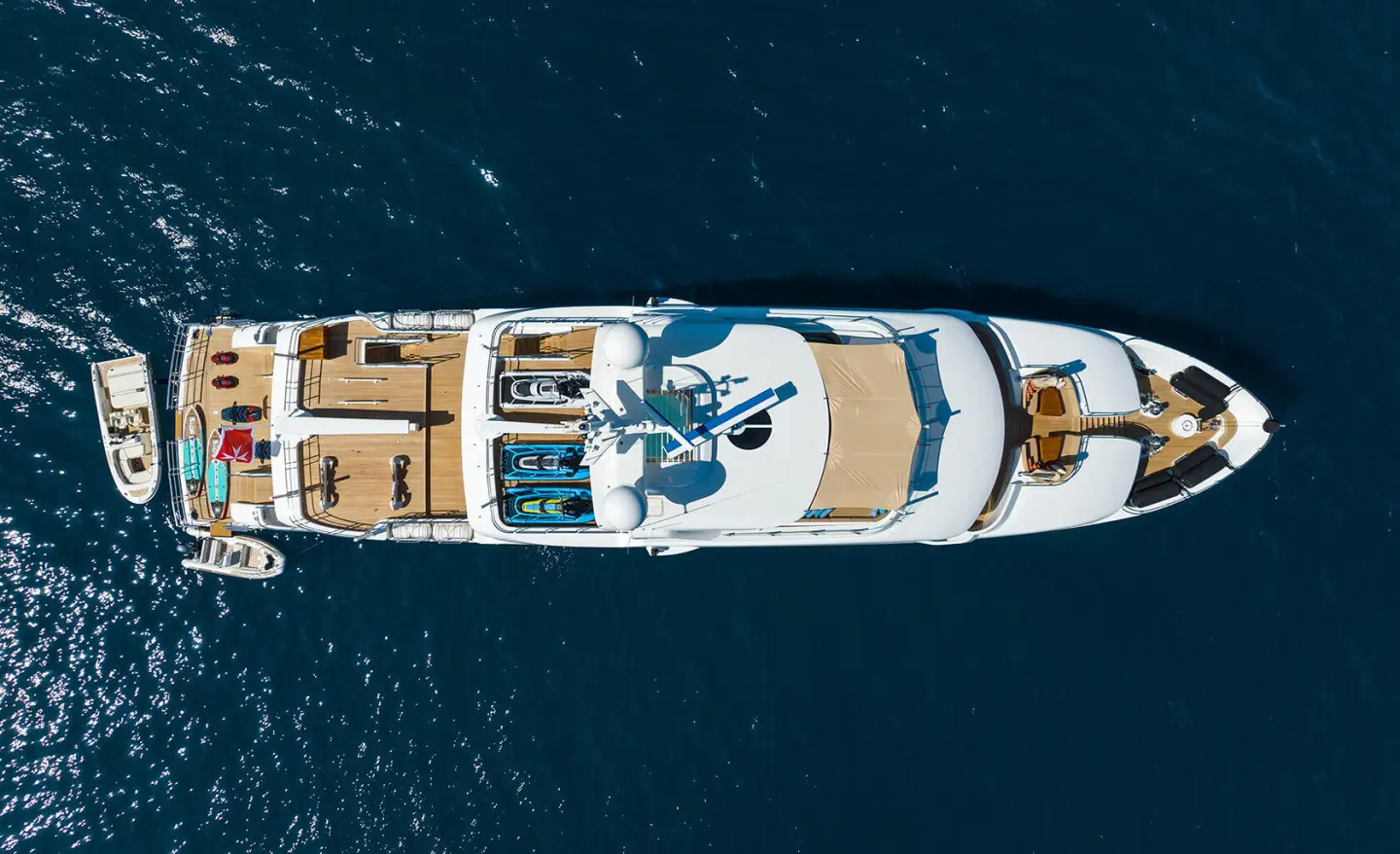 Top-down view of Serenity luxury yacht anchored in calm blue water with deck seating