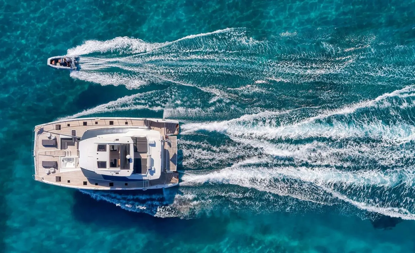 Aerial view of Christal Mio motor yacht sailing through blue sea wake