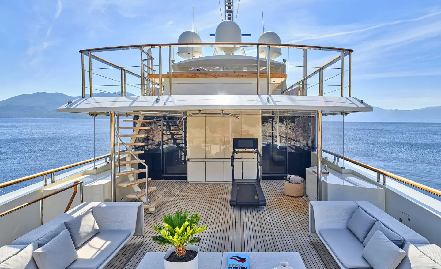 La Pellegrina 1 yacht lounge on deck at sunset with seating and plants