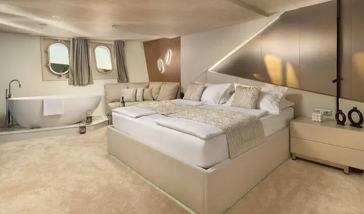 Master cabin with large bed, nightstands, and ensuite bath on Cristal yacht