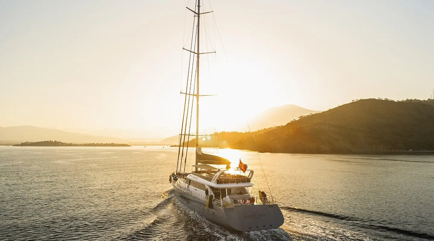 North Wind luxury sailing yacht cruising at sunset along a calm sea