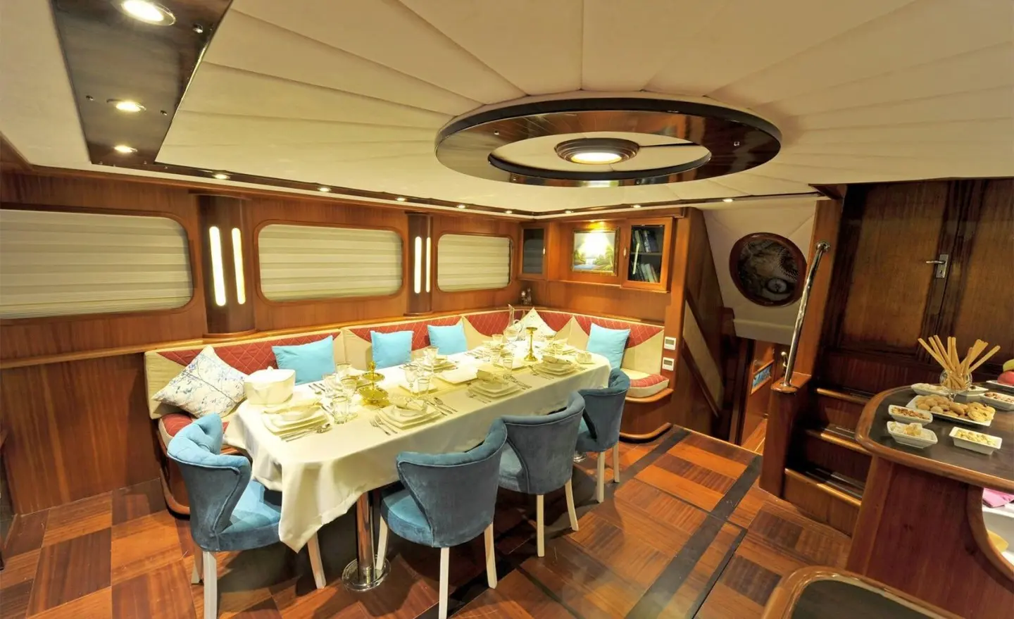 Interior of a luxury gulet yacht with a dining table set for guests