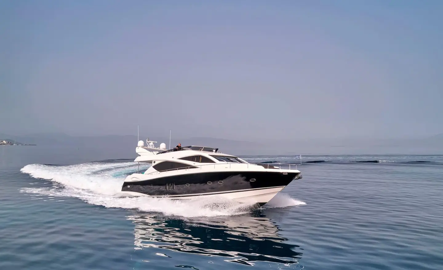 M Five motor yacht cruising on calm blue sea with clear sky