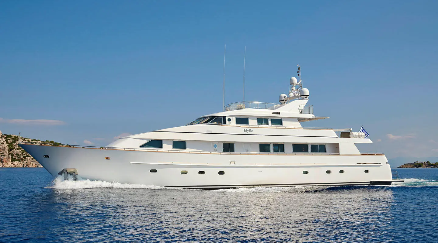 Idylle luxury yacht anchored on calm blue water with clear sky