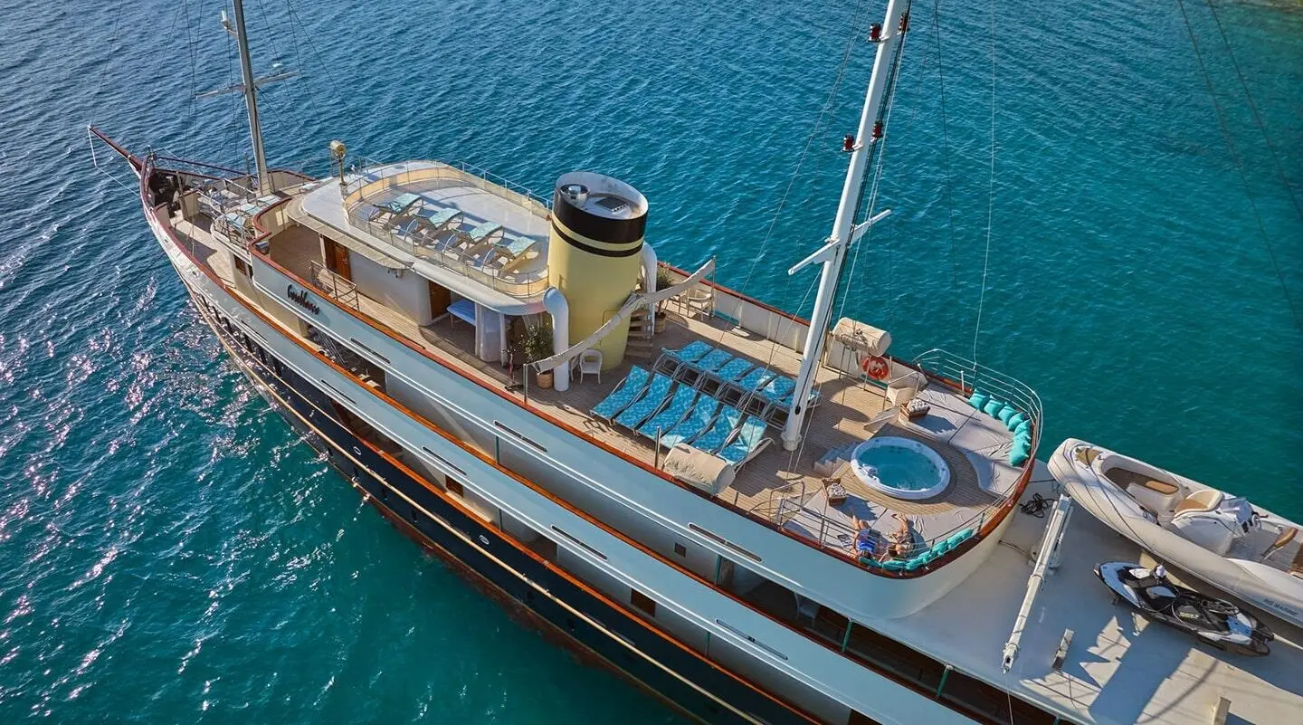 Top-down view of Casablanca yacht anchored in blue sea, deck lounge area visible