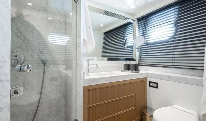 Illusion II cabin bed and kitchenette area with wooden cabinet and porthole