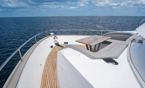 Quantum yacht deck at sunrise, white hull, teak deck, blue sea, calm waters