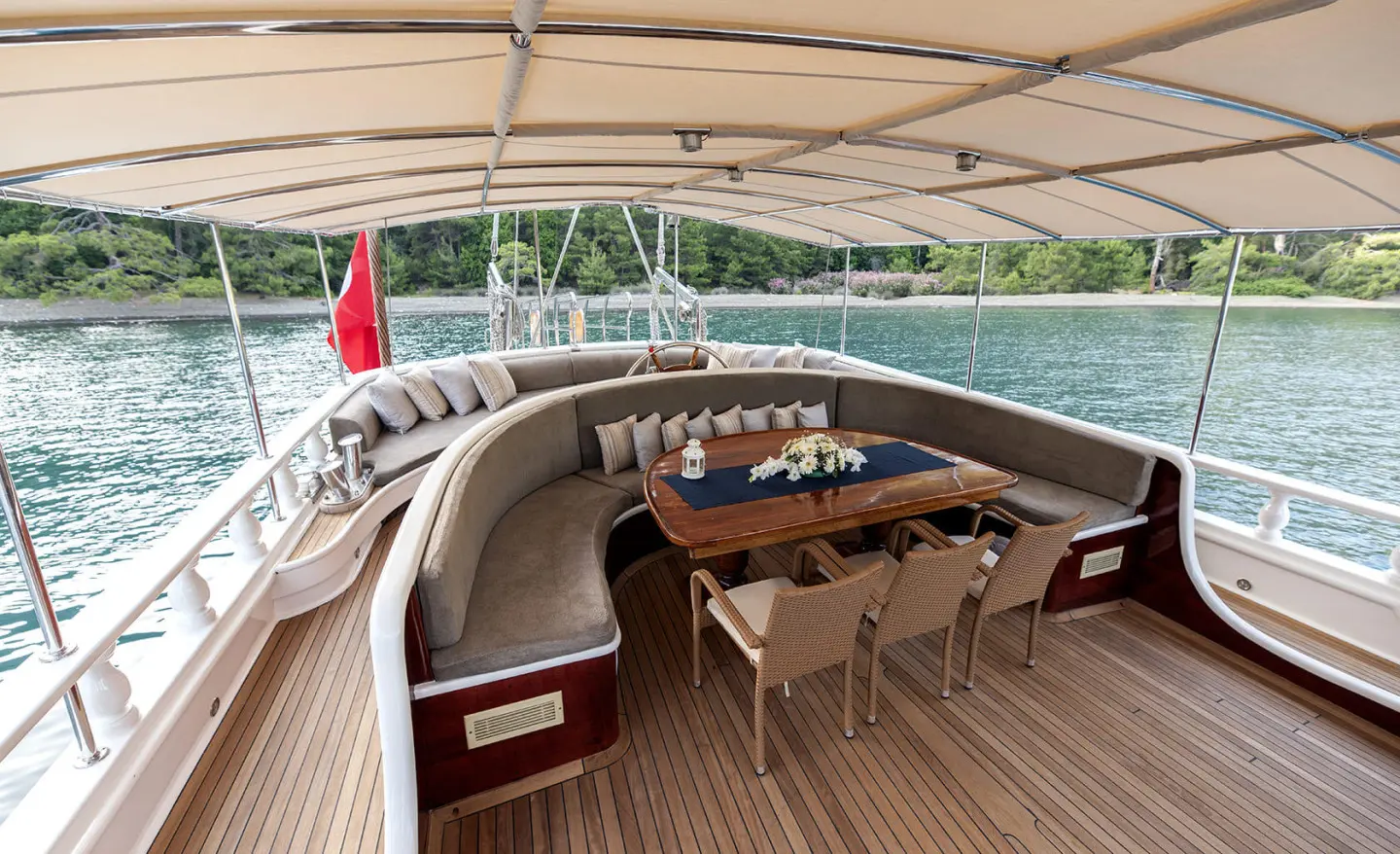 Kayhan 5 gulet aft deck seating area with table and cushions, open water view