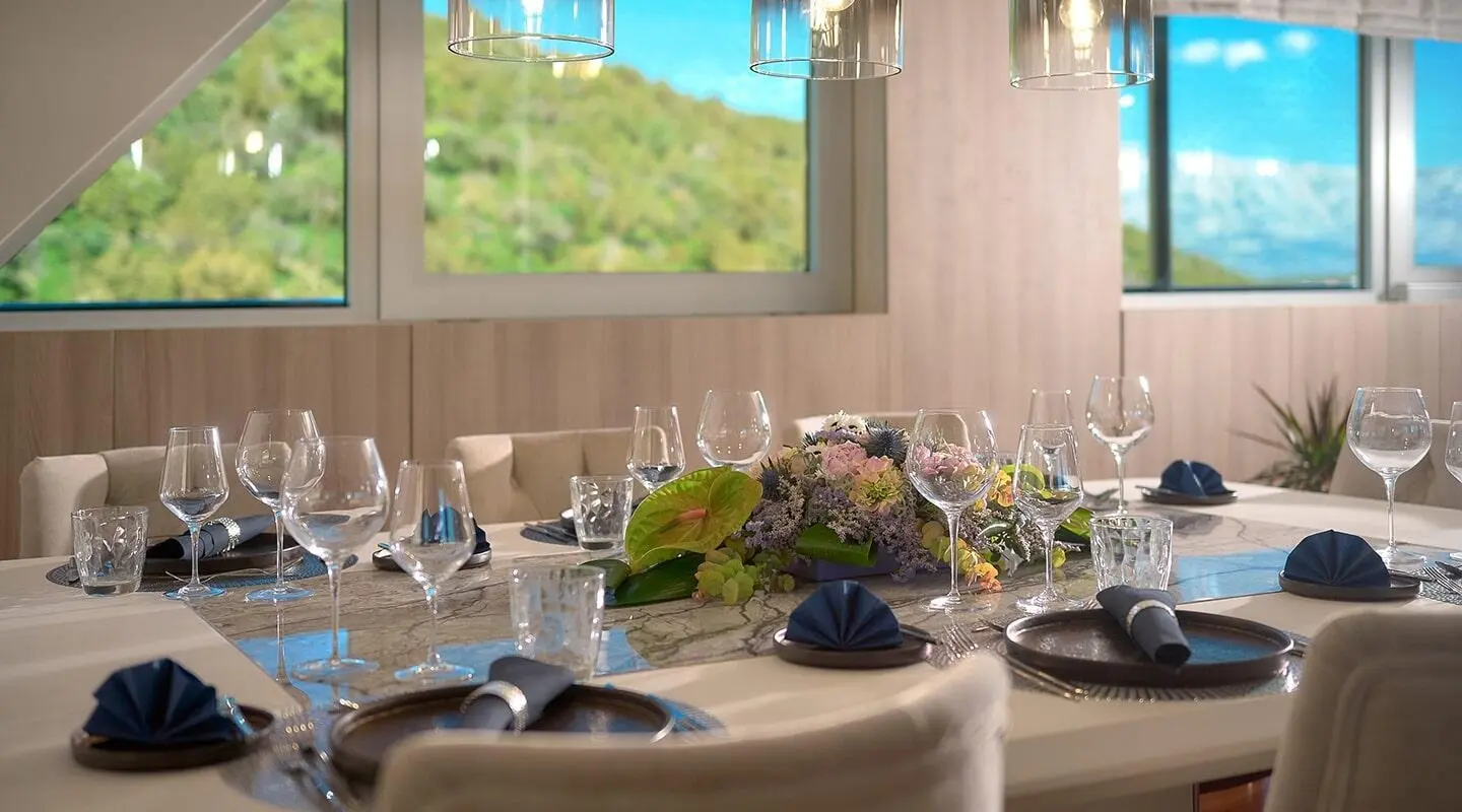 Cristal yacht interior dining table set for luxury charter with floral centerpiece