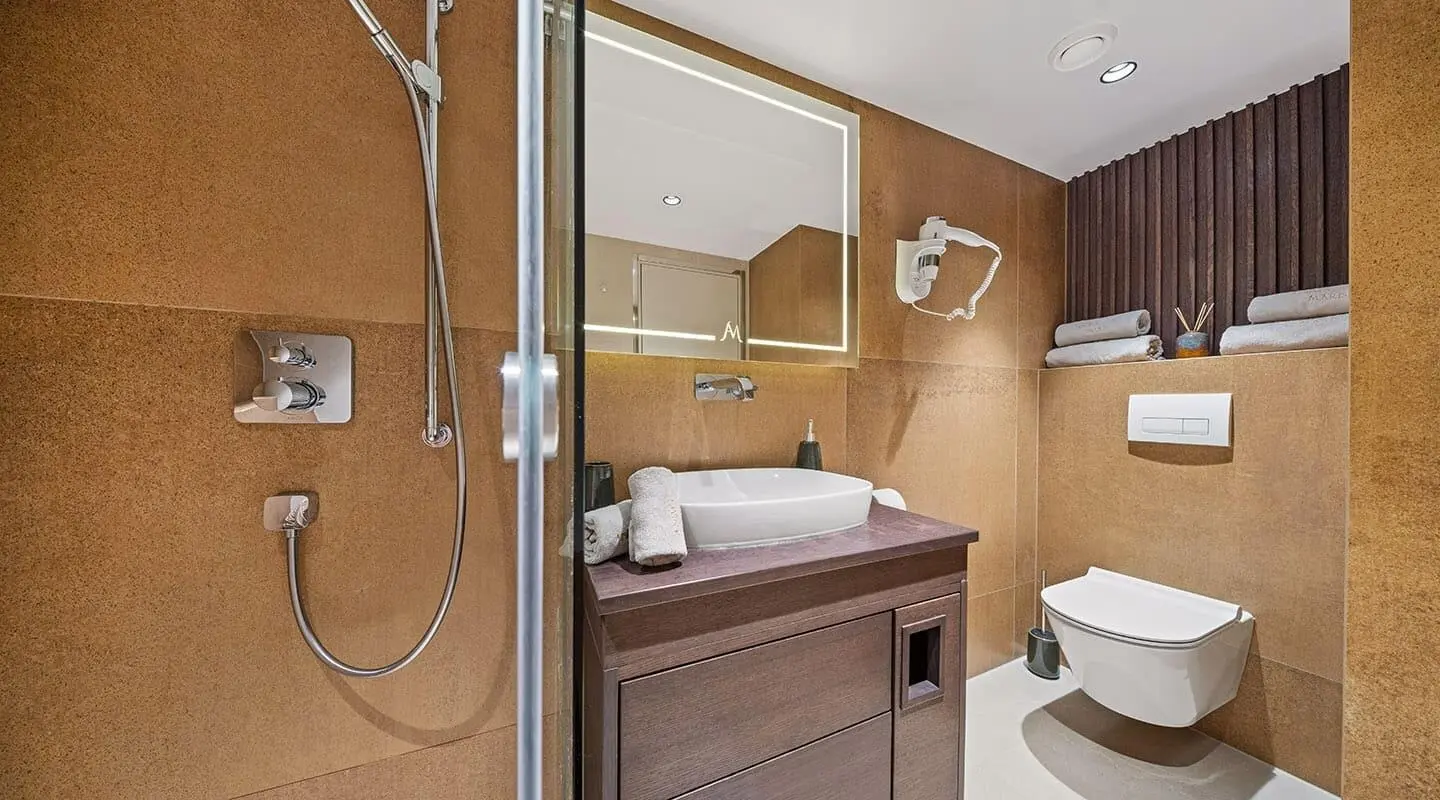 Luxurious yacht bathroom on Anima Maris with sink, mirror, and shower area