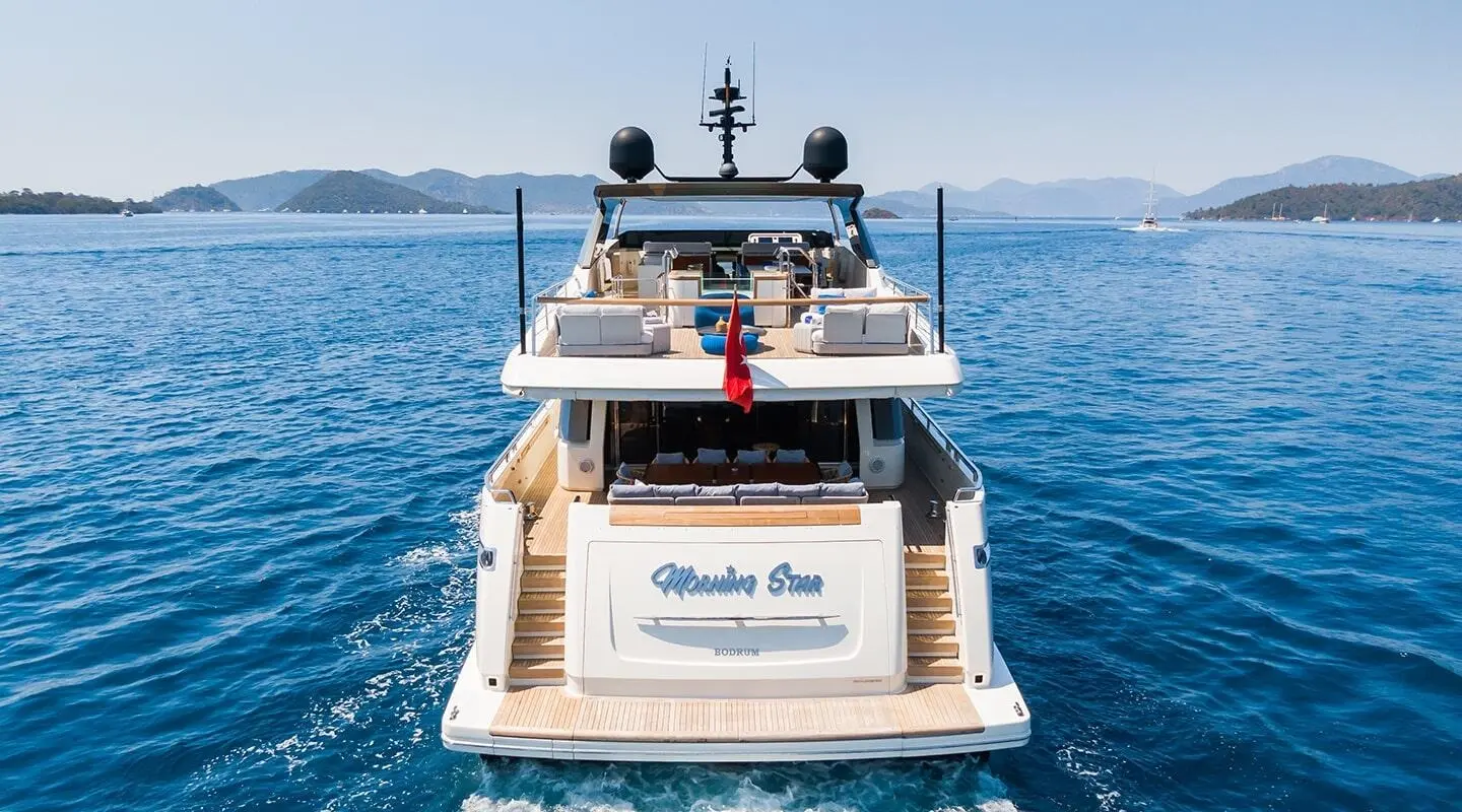 Morning Star yacht seen from rear on calm blue sea at sunset