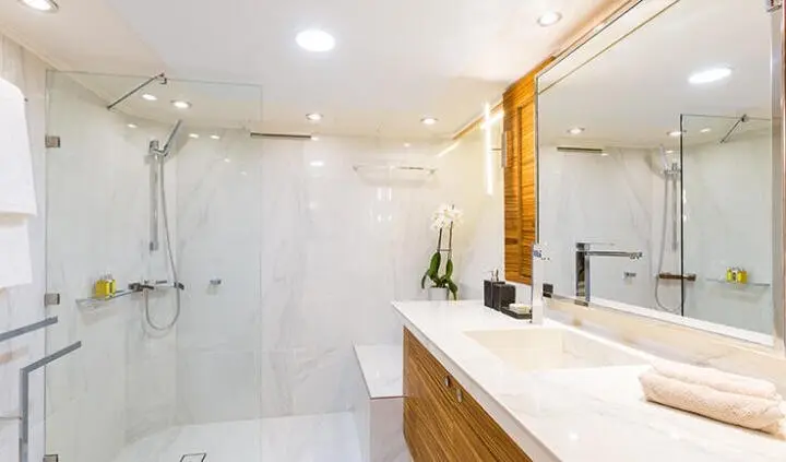 Master cabin with king bed and ensuite bathroom on Aquarella yacht, bright space