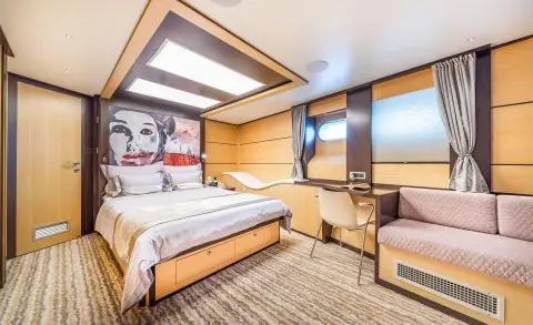 Navilux master cabin on a motor yacht with large window, two beds, and decor
